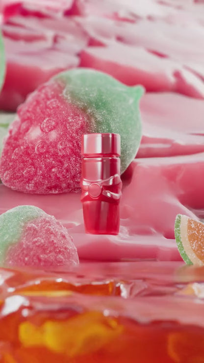 Flacon de parfum rose et or avec ruban doré pour les fans de Yara Candy